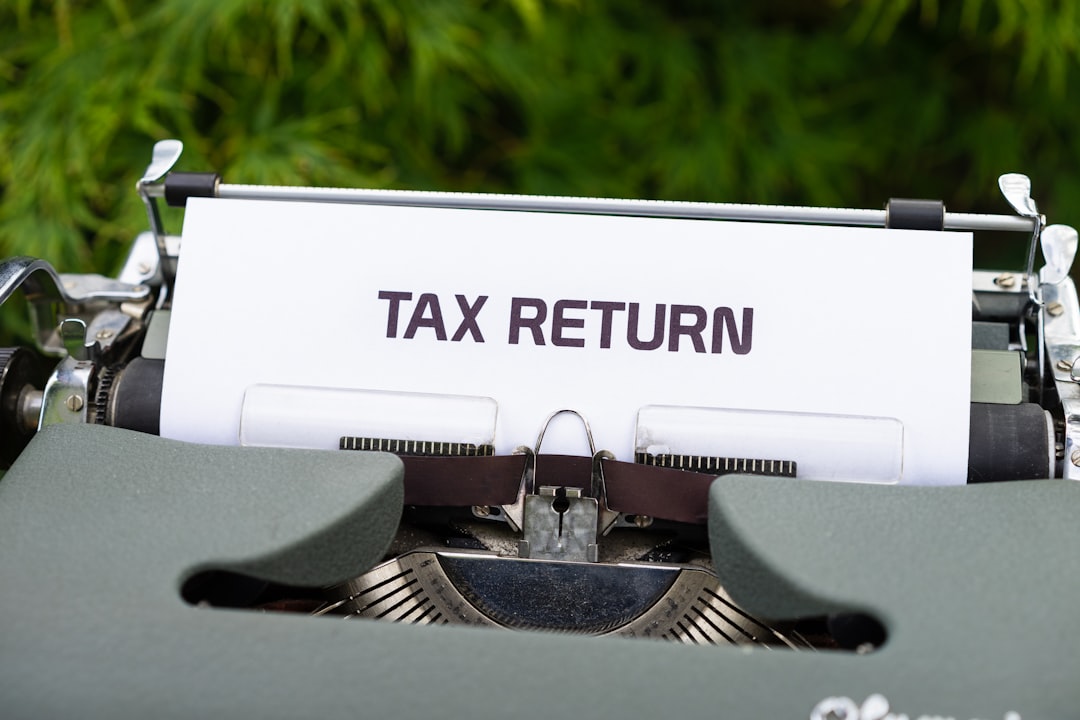 heros-img a-close-up-of-a-typewriter-with-a-tax-return-sign-on-it-ber3q-zehd4