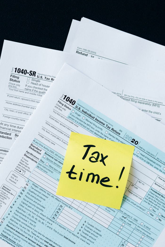 about-us-01 IRS 1040 tax forms with handwritten Tax Time! note for filing reminder.
