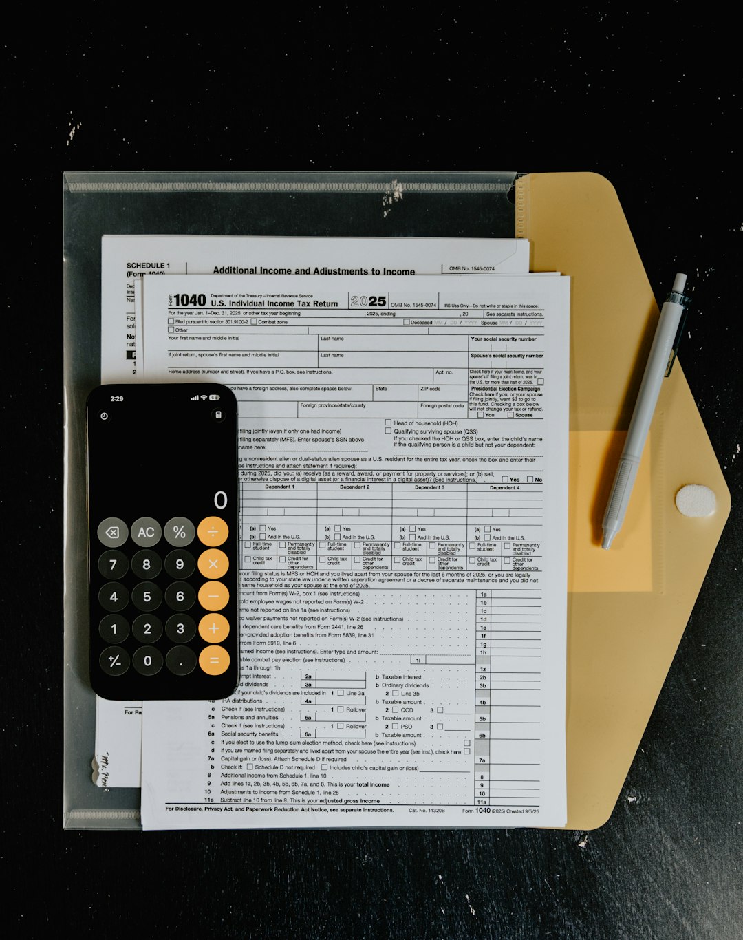about-us-02 tax-forms-with-calculator-and-pen-on-desk-s0ii1aqa9gi